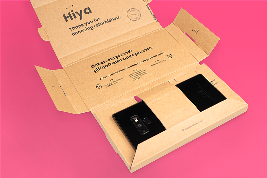 An opened brown box with a phone and some text inside